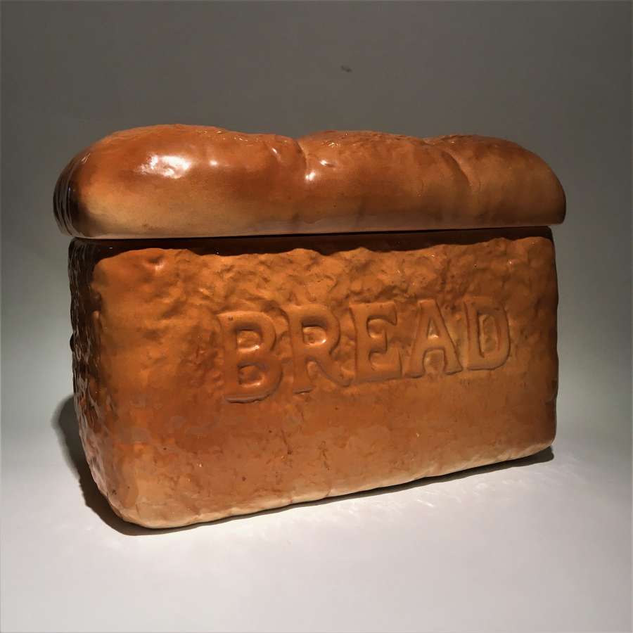 A trompe l'oeil pottery bread bin shaped like a loaf of bread