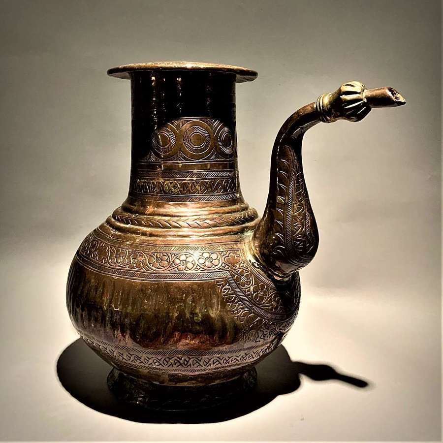 An antique Islamic Ottoman tinned copper and brass ewer (