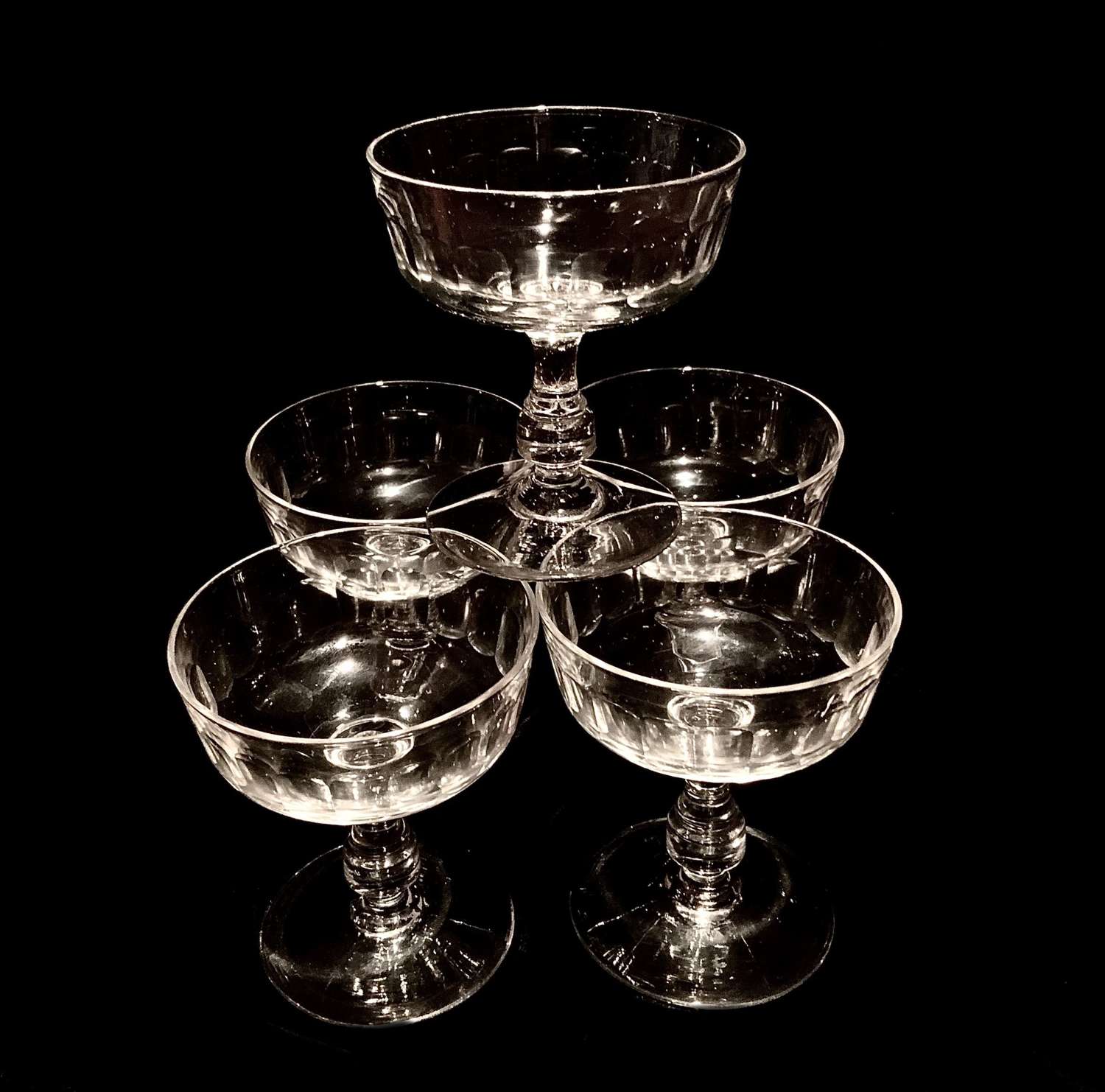 A set of five (5) matching champagne glasses, coupes or boats